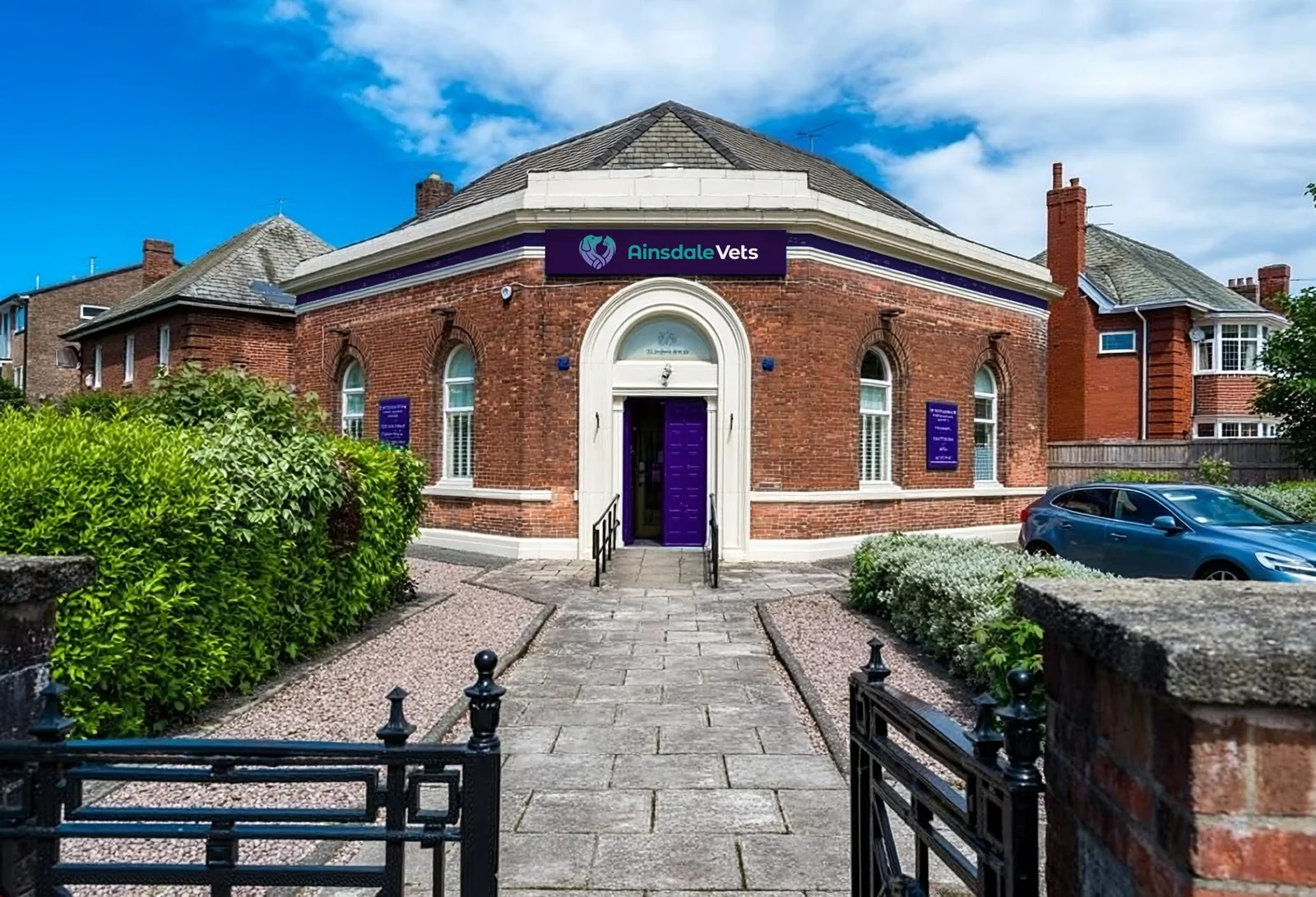 Brick exterior and purple entrance of Ainsdale Vets