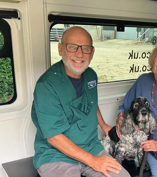 VetsGo veterinary surgeon with dogs inside the mobile veterinary vehicle
