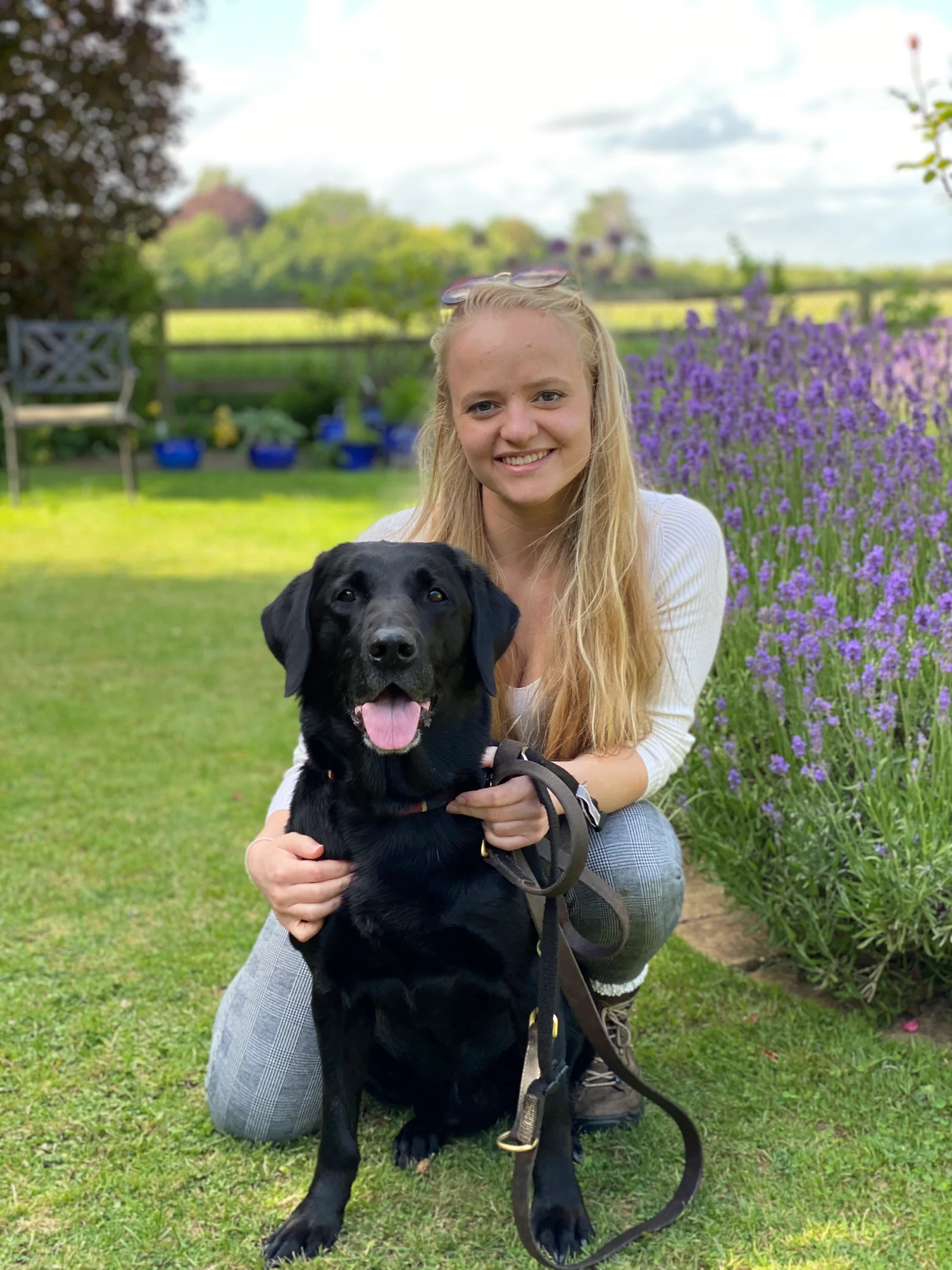 Nirvana Vets co-director Kate with a black Labrador