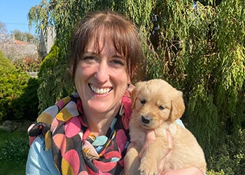 Veterinary surgeon Helen Jones with a puppy at Peaceful Paws in Bristol